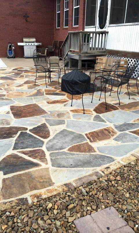 Outdoor entertainment space with stone flooring