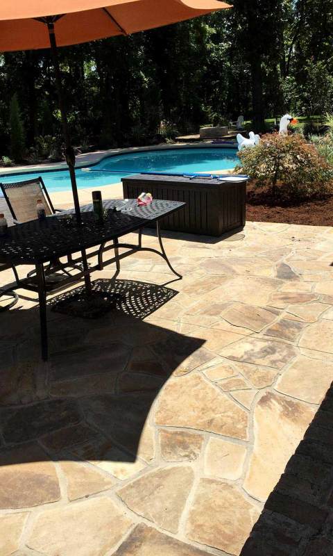 Elegant stone swimming pool deck