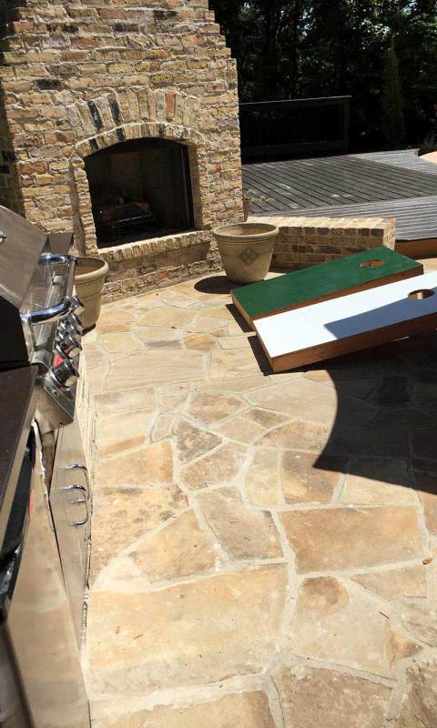 Outdoor fireplace and deck in two types of stone