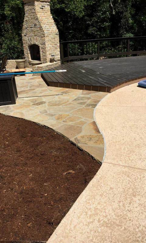 Outdoor fireplace with stone front, and stone path